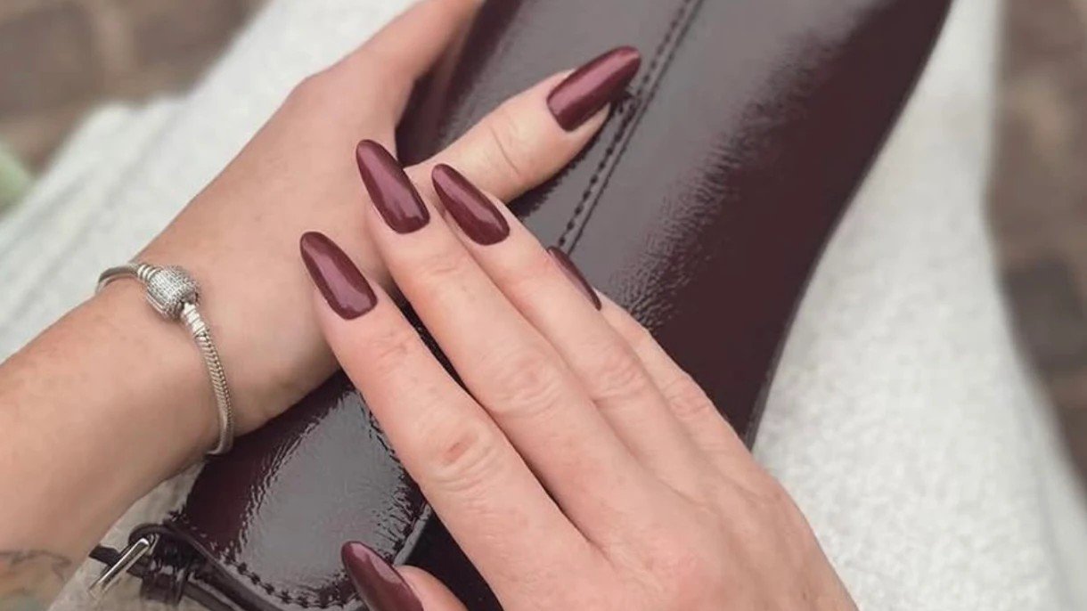 Long almond nails in a deep burgundy colour