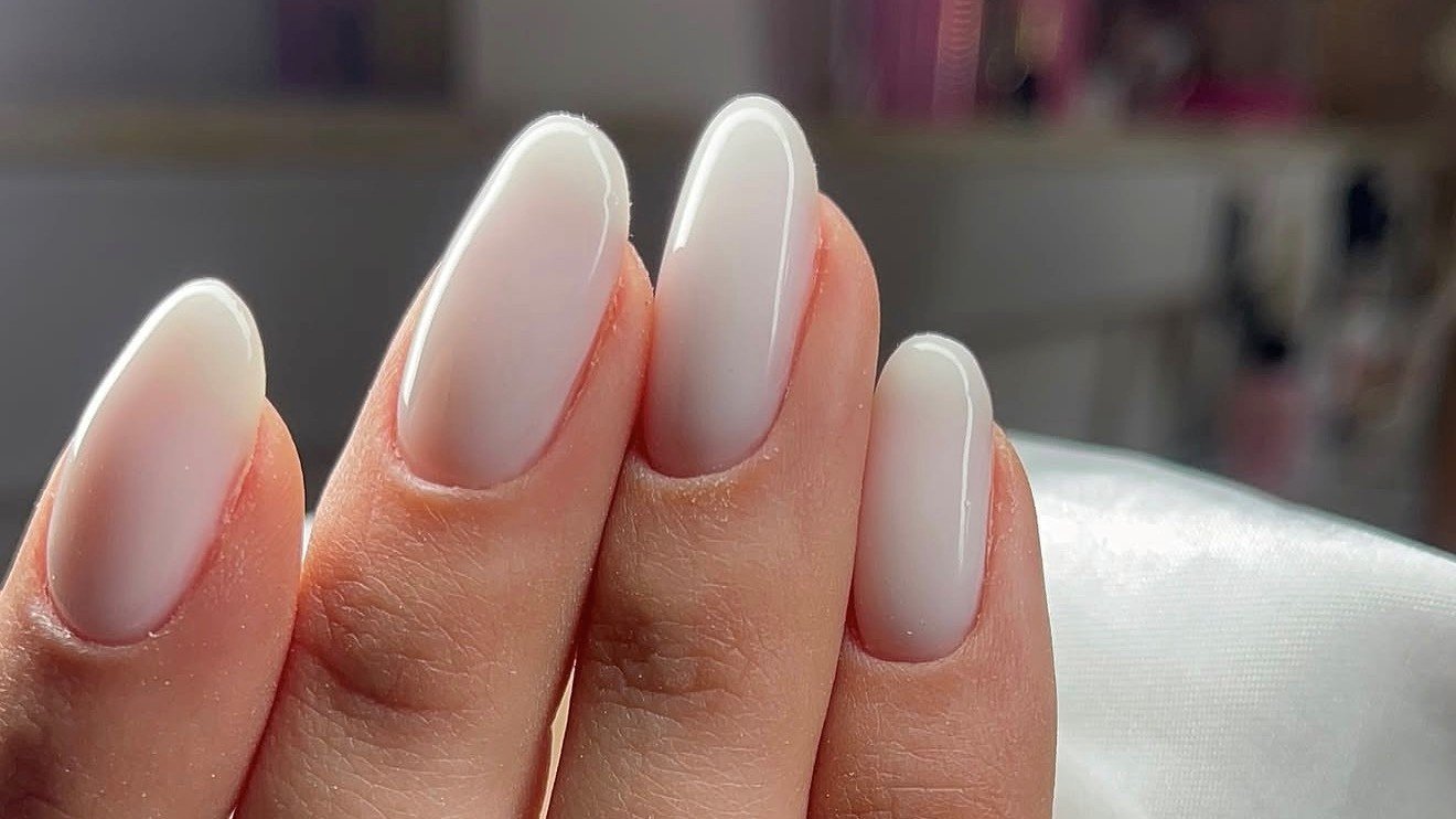 Milky nude gel finish on almond-shaped nails