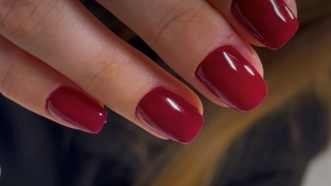 Short square nails with a glossy red gel finish