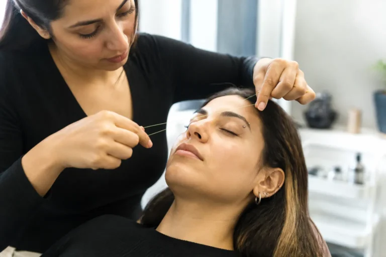 Editorial cover photograph about eyebrow threading with a brow piercing