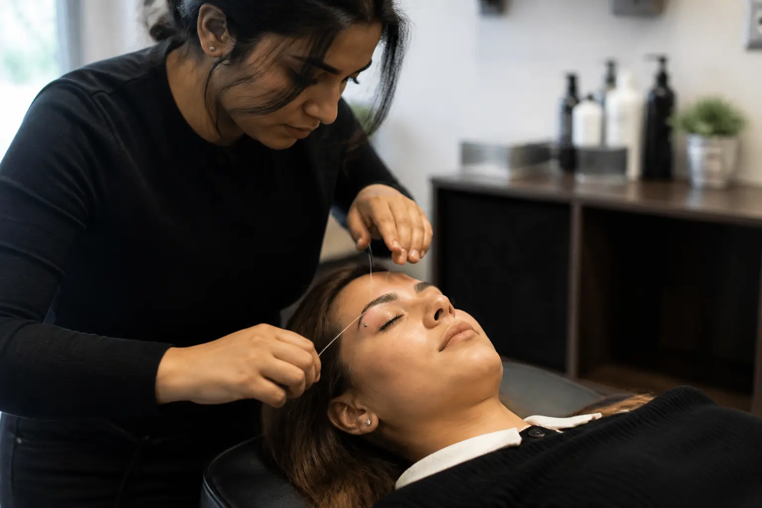 Supporting editorial photograph about eyebrow threading with a brow piercing