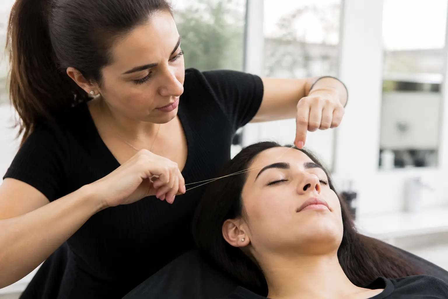 Supporting editorial photograph about threading thick brows